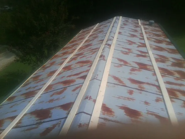 Rusted metal roof panels with new wood purlins before replacement — Storm Damage Roof Repair in Taylors by Roofing Brothers
